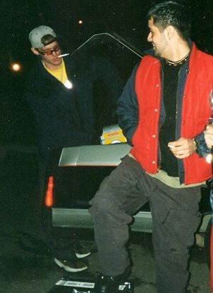 Early 90s night shot, young DJ Natural Nate® with a friend outside by a car